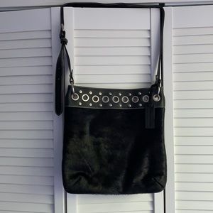 Crossbody with grommets and fox fur.